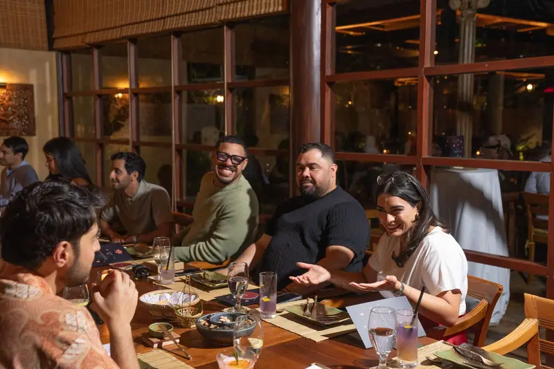 Members laughing at Vol 01 dinner — Monsoon